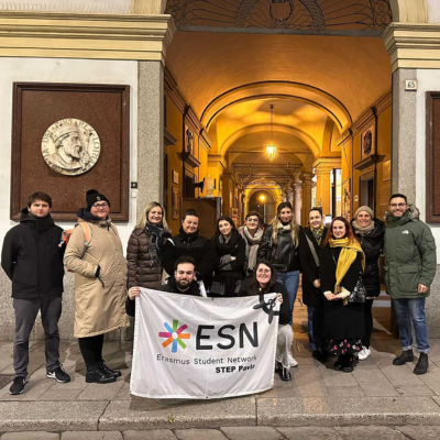 Group of people together holding a flag